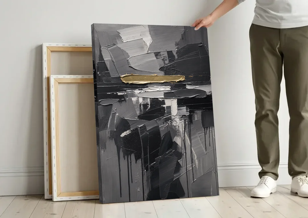 Black and Gold Abstract Knife Field for the Modern Office canvas wall art leaning against a wall next to blank canvases