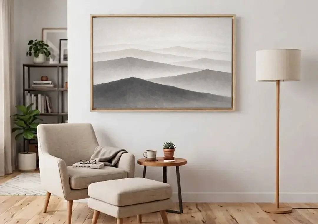 Black and White Bedroom Wall Art of Misty Ridges canvas wall art above an armchair in a bright living room
