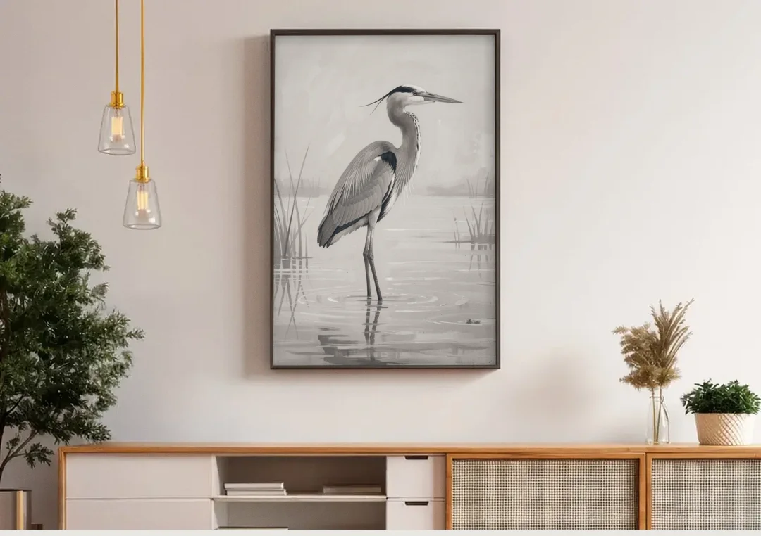 Black and White Bird Painting of a Marsh Heron canvas wall art above a wooden sideboard under pendant lights