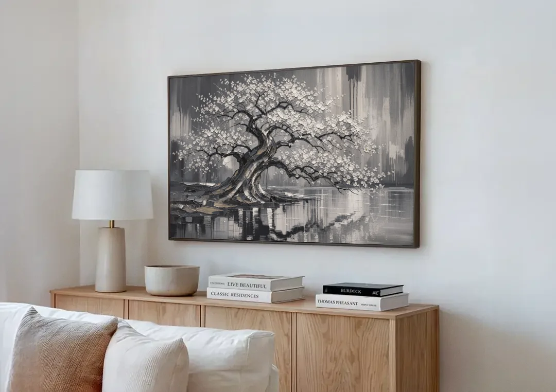 Black and White Cherry Blossom Over a Still Pond canvas wall art above a wooden sideboard next to a sofa