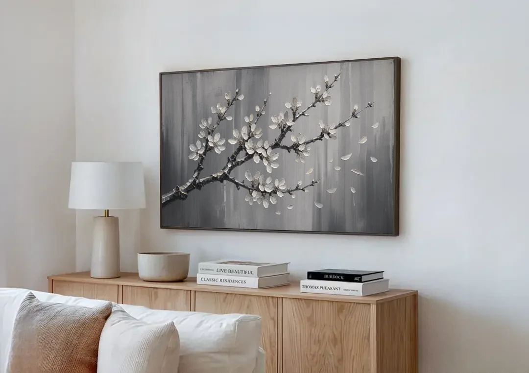 Black and White Cherry Blossom Painting with Drifting Petals canvas wall art above a wooden sideboard next to a sofa