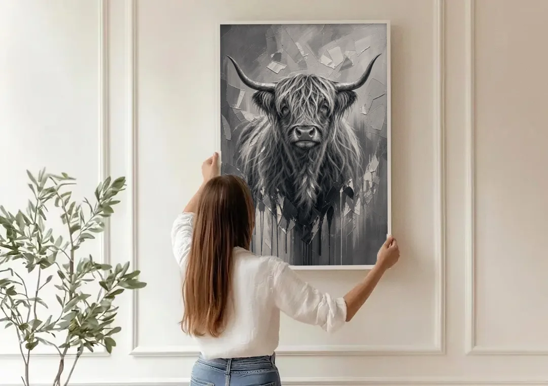 Black and White Farmhouse Shaggy Highland Cow canvas wall art being hung on a paneled wall
