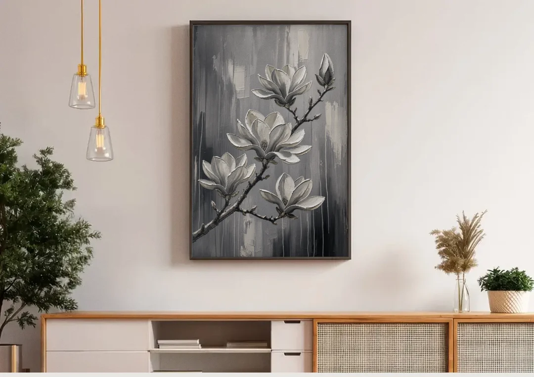 Black and White Floral Canvas of a Magnolia Branch canvas wall art above a wooden sideboard under pendant lights