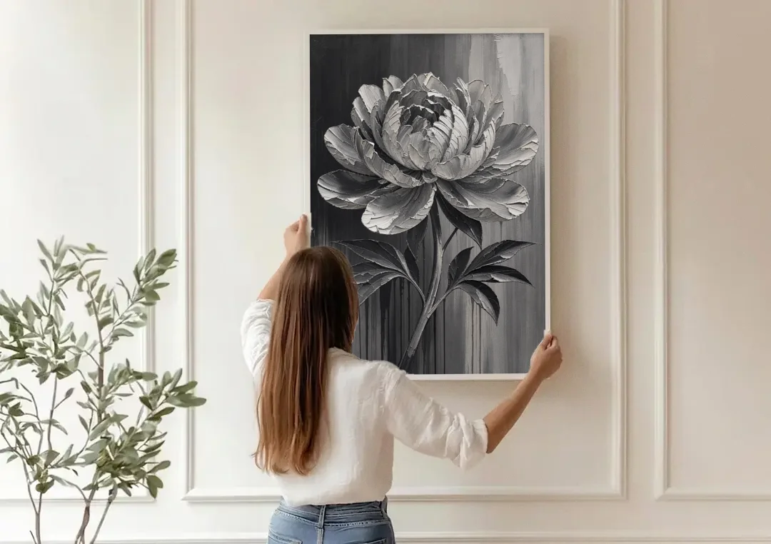 Black and White Flower Painting of a Peony canvas wall art being hung on a paneled wall