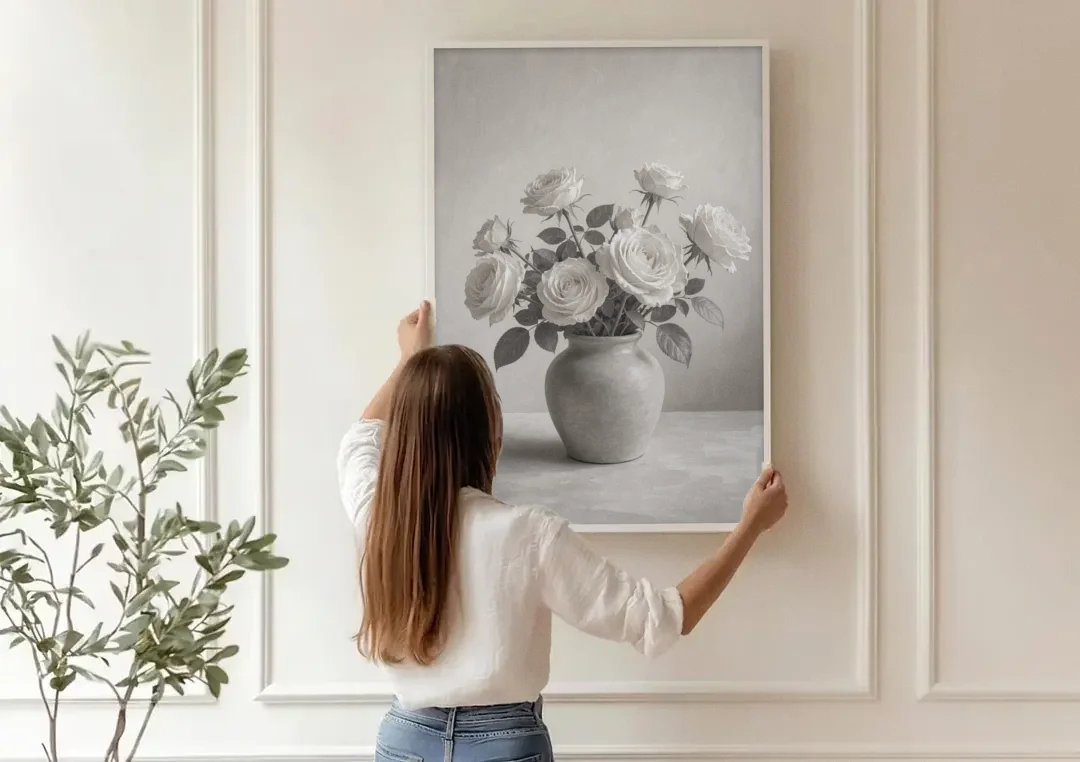 Black and White Garden Roses in a Stone Vase canvas wall art being hung on a paneled wall