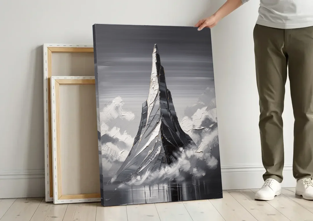 Black and White Granite Mountain Spire canvas wall art leaning against a wall next to blank canvases