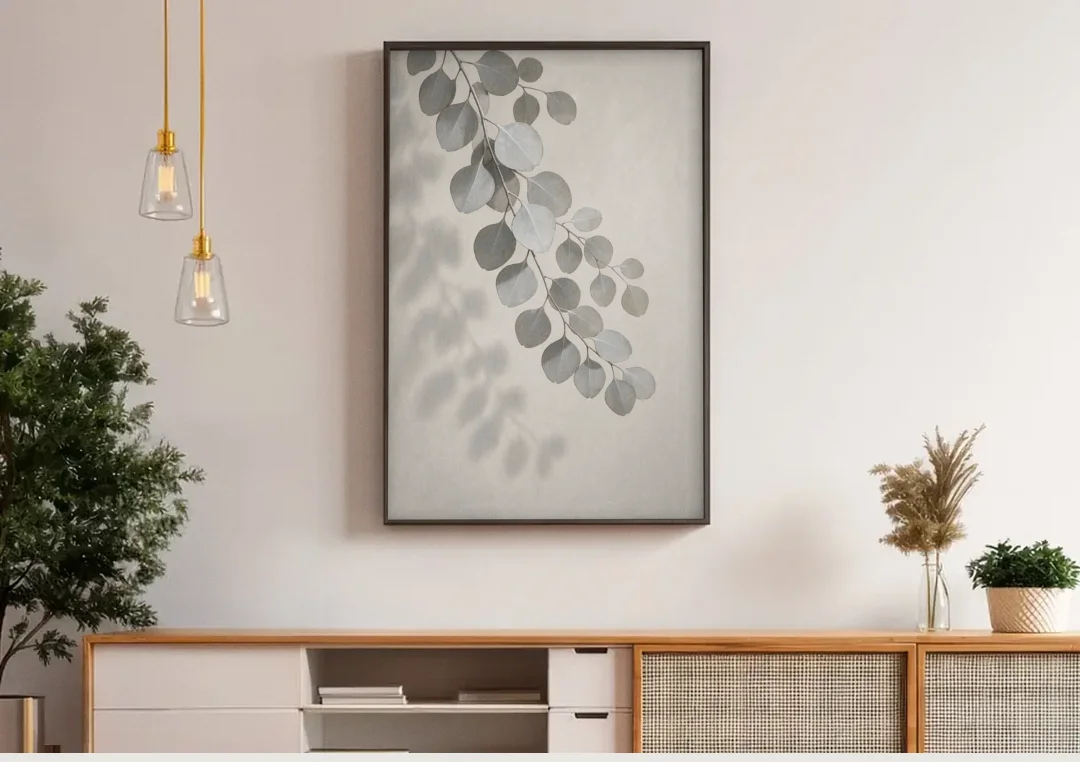 Black and White Hanging Eucalyptus Branch canvas wall art above a wooden sideboard under pendant lights