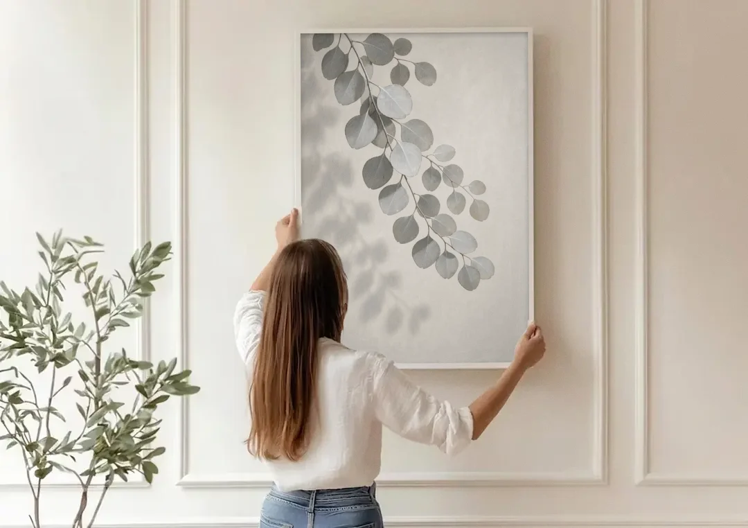 Black and White Hanging Eucalyptus Branch canvas wall art being hung on a paneled wall