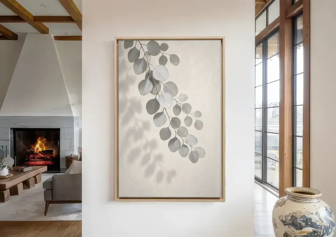 Black and White Hanging Eucalyptus Branch canvas wall art in a living room with a fireplace