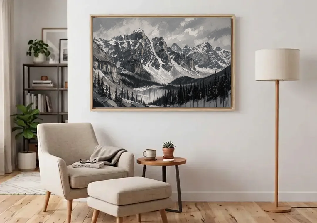 Black and White Landscape Wall Art of Alpine Peaks canvas wall art above an armchair in a bright living room