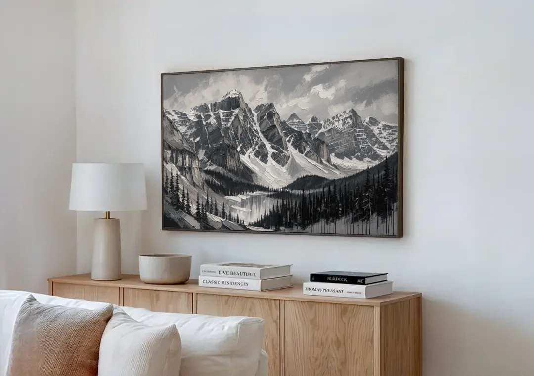 Black and White Landscape Wall Art of Alpine Peaks canvas wall art above a wooden sideboard next to a sofa