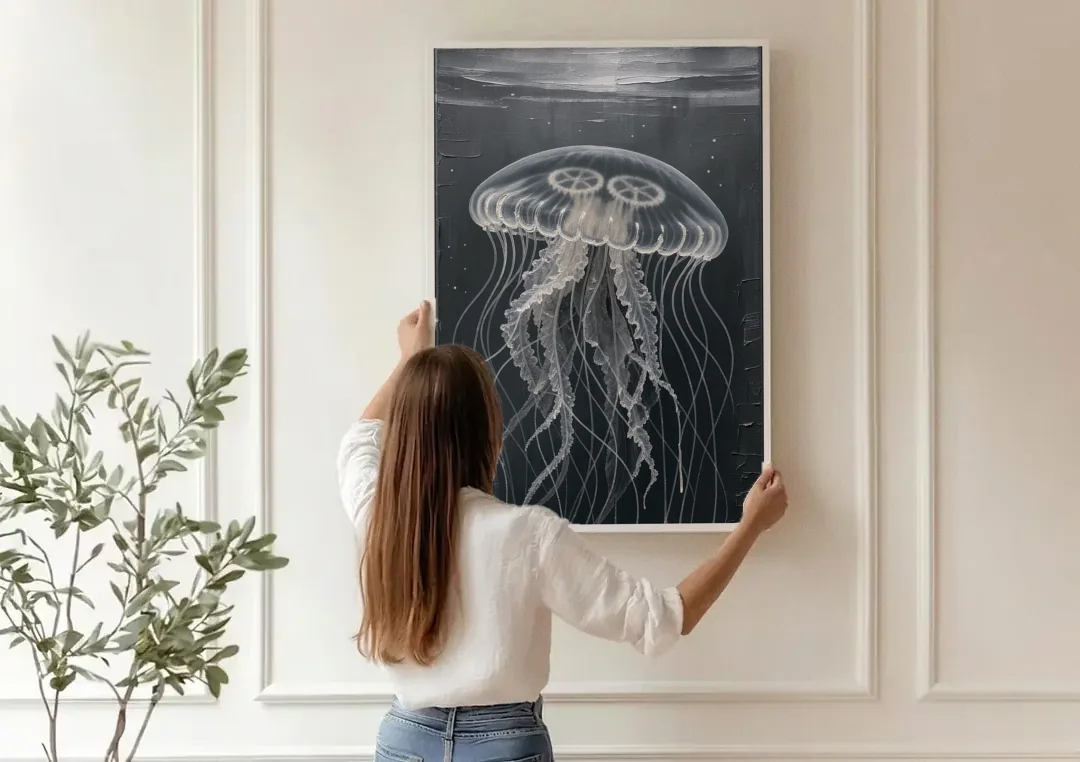 Black and White Moon Jellyfish in Dark Coastal Water canvas wall art being hung on a paneled wall