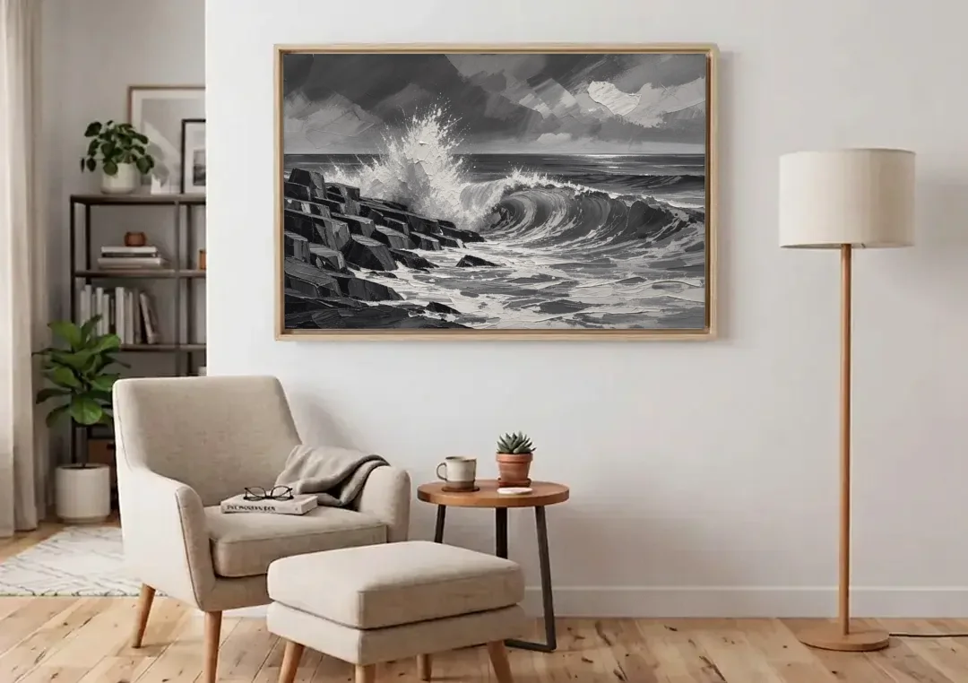 Black and White Paintings of a Crashing Wave canvas wall art above an armchair in a bright living room