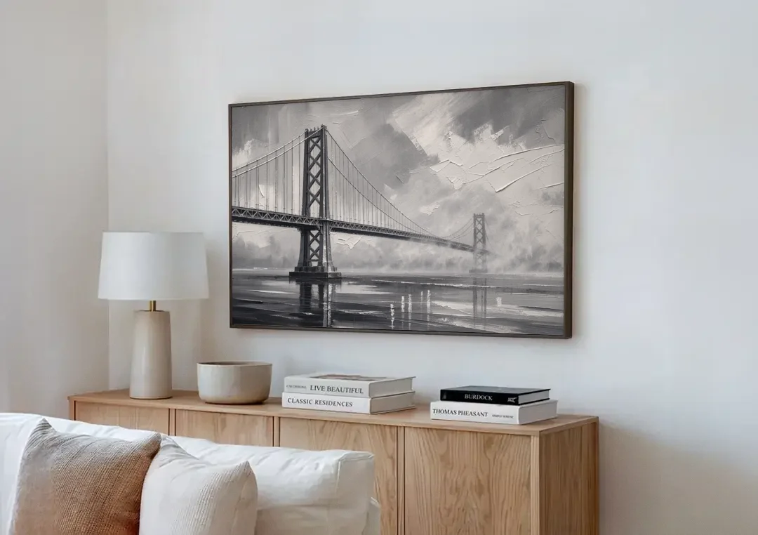 Black and White Panoramic Wall Art of a Bridge canvas wall art above a wooden sideboard next to a sofa