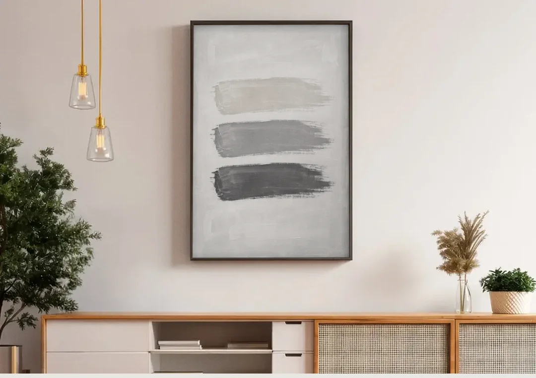 Black and White Stacked Brush Stroke Trio canvas wall art above a wooden sideboard under pendant lights