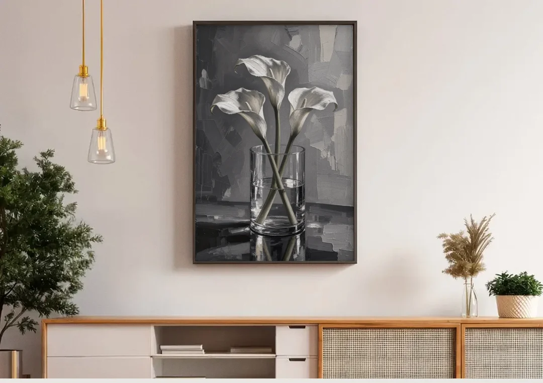 Black and White Still Life Painting Calla Lilies canvas wall art above a wooden sideboard under pendant lights