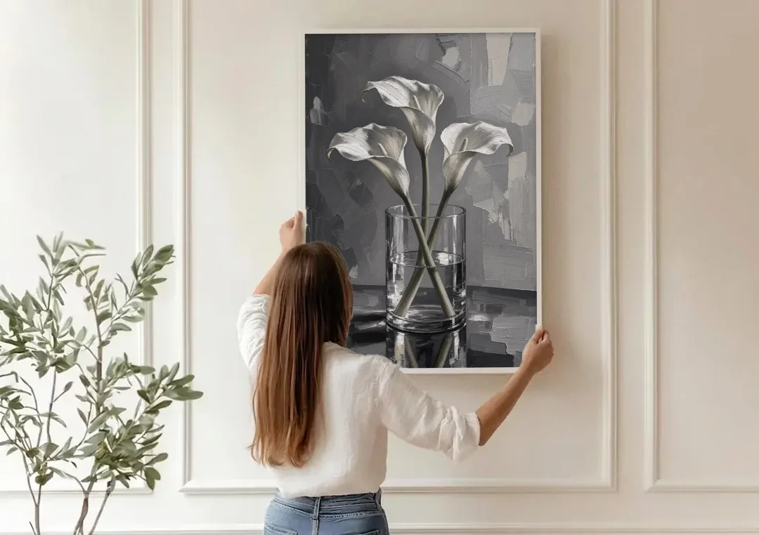 Black and White Still Life Painting Calla Lilies canvas wall art being hung on a paneled wall
