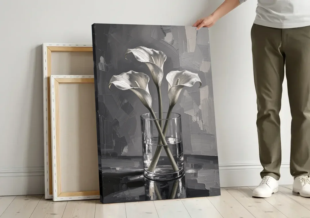 Black and White Still Life Painting Calla Lilies canvas wall art leaning against a wall next to blank canvases