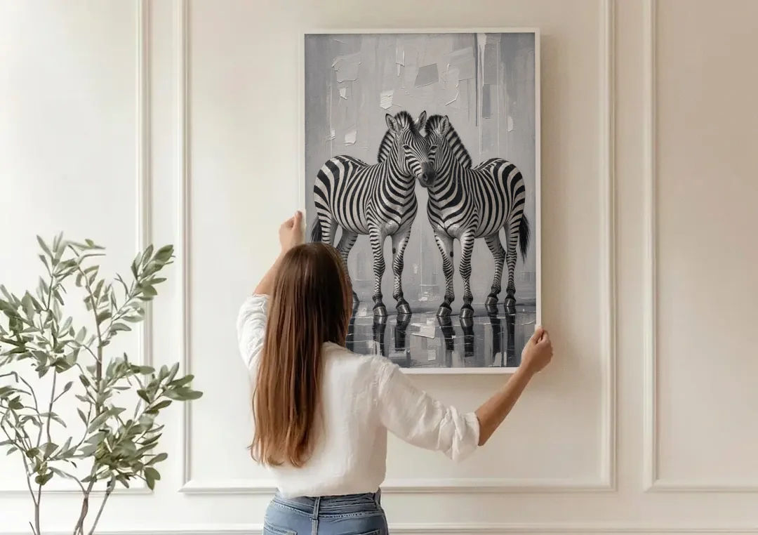 Black and White Zebra Grooming Pair in Palette Knife canvas wall art being hung on a paneled wall