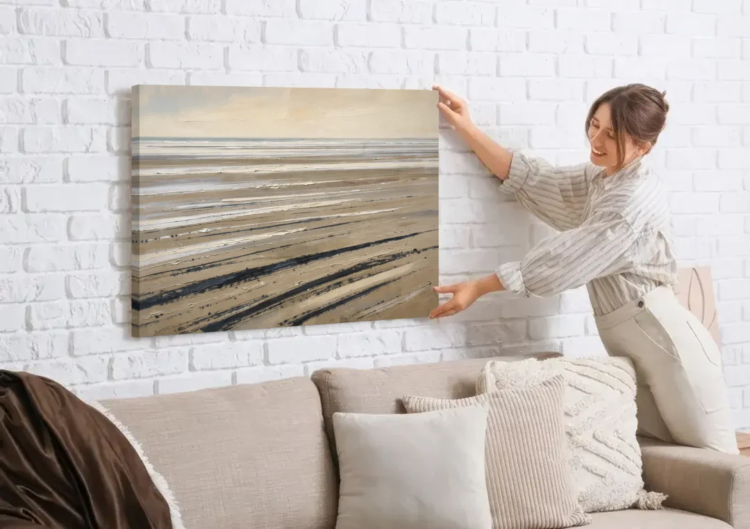 Black Brush Stroke Painting of Low Tide Sand canvas wall art being hung on a white brick wall above a sofa