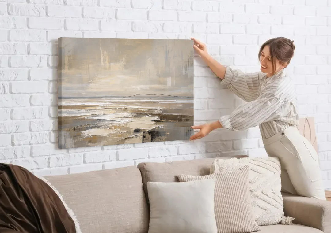 Black Line Abstract Painting Across a Salt Flat canvas wall art being hung on a white brick wall above a sofa