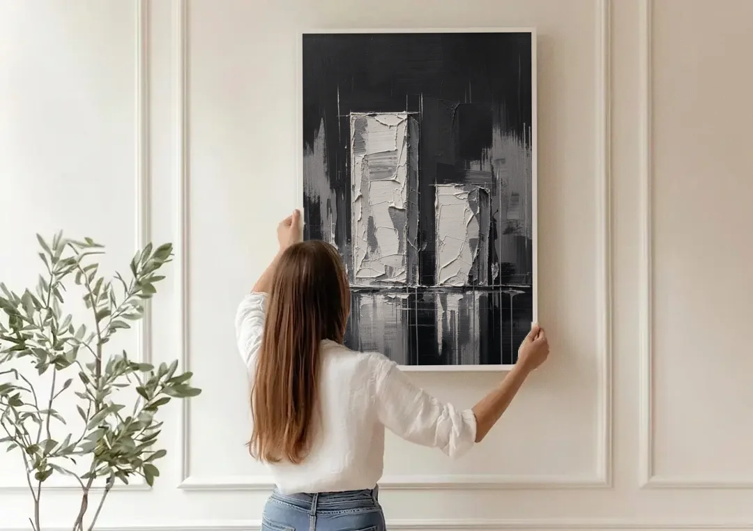 Black Minimalist Wall Art of Tall and Short Blocks canvas wall art being hung on a paneled wall