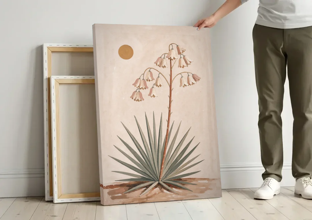 Blooming Yucca Stalk with Cream Bells canvas wall art leaning against a wall next to blank canvases