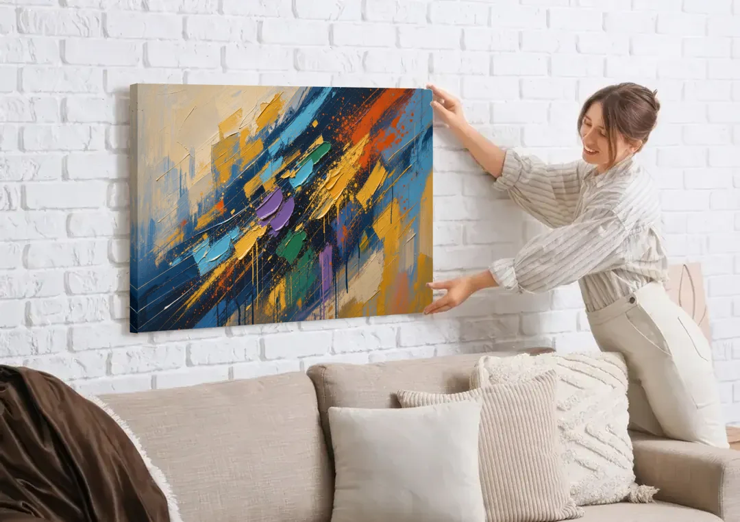 Blue Abstract Jewel Splatter Sweep canvas wall art being hung on a white brick wall above a sofa