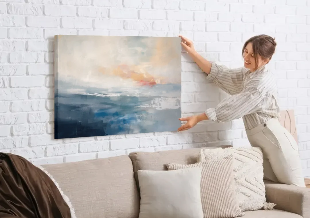 Blue Abstract Painting of a Misty Dawn Horizon canvas wall art being hung on a white brick wall above a sofa