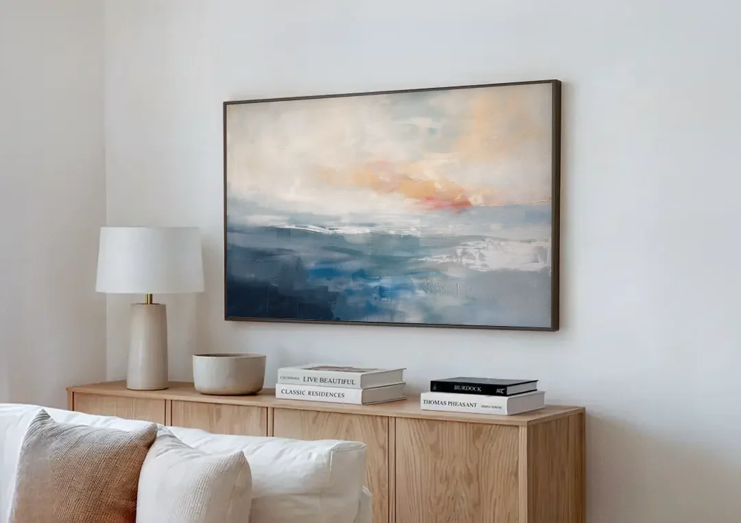 Blue Abstract Painting of a Misty Dawn Horizon canvas wall art above a wooden sideboard next to a sofa
