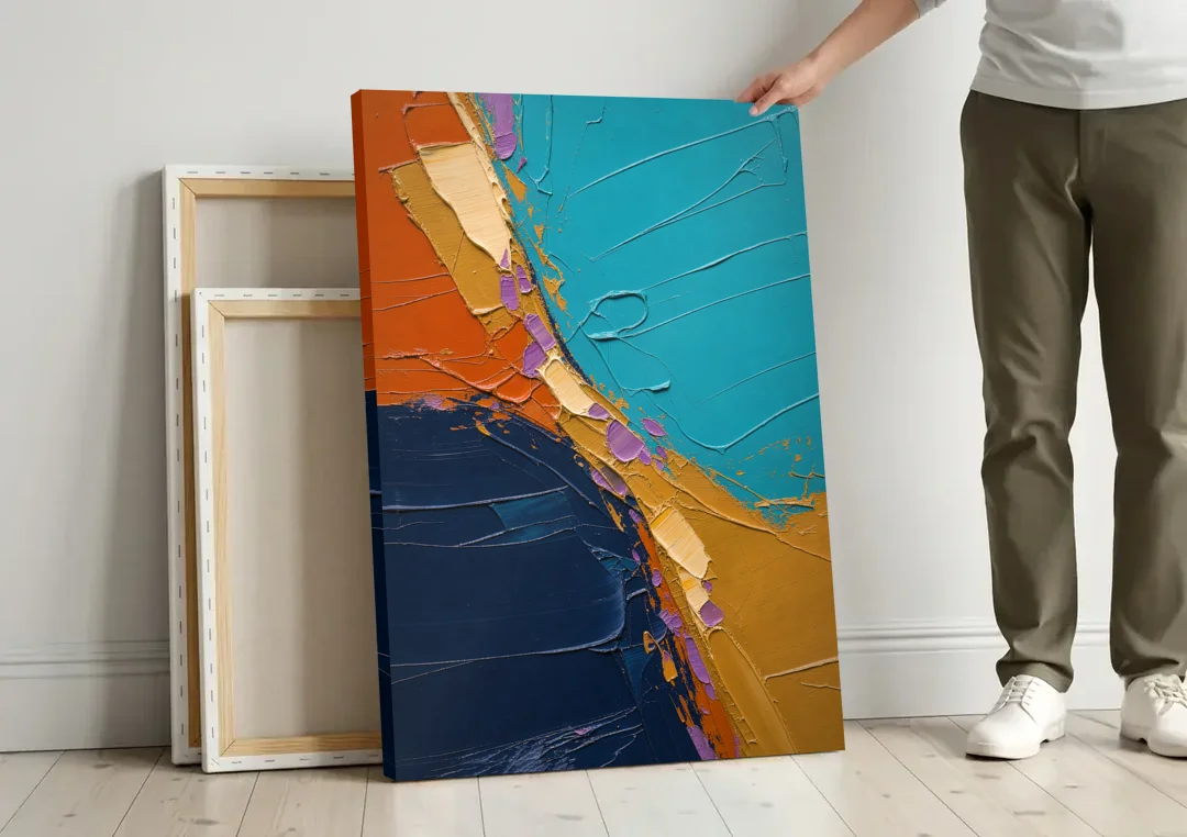 Blue and Orange Abstract Painting with Violet Chips canvas wall art leaning against a wall next to blank canvases
