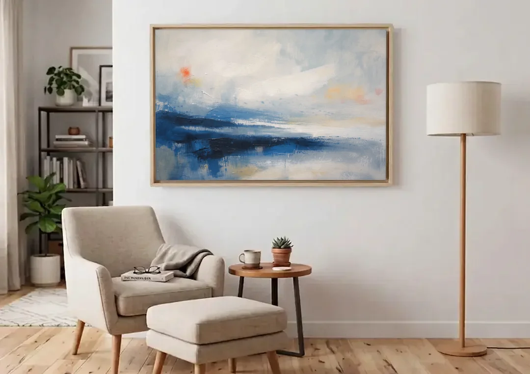 Blue and White Abstract Painting of Tidal Mist canvas wall art above an armchair in a bright living room