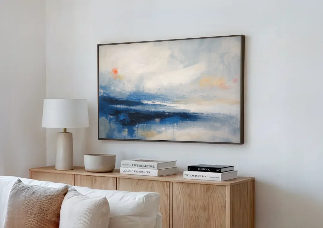 Blue and White Abstract Painting of Tidal Mist canvas wall art above a wooden sideboard next to a sofa