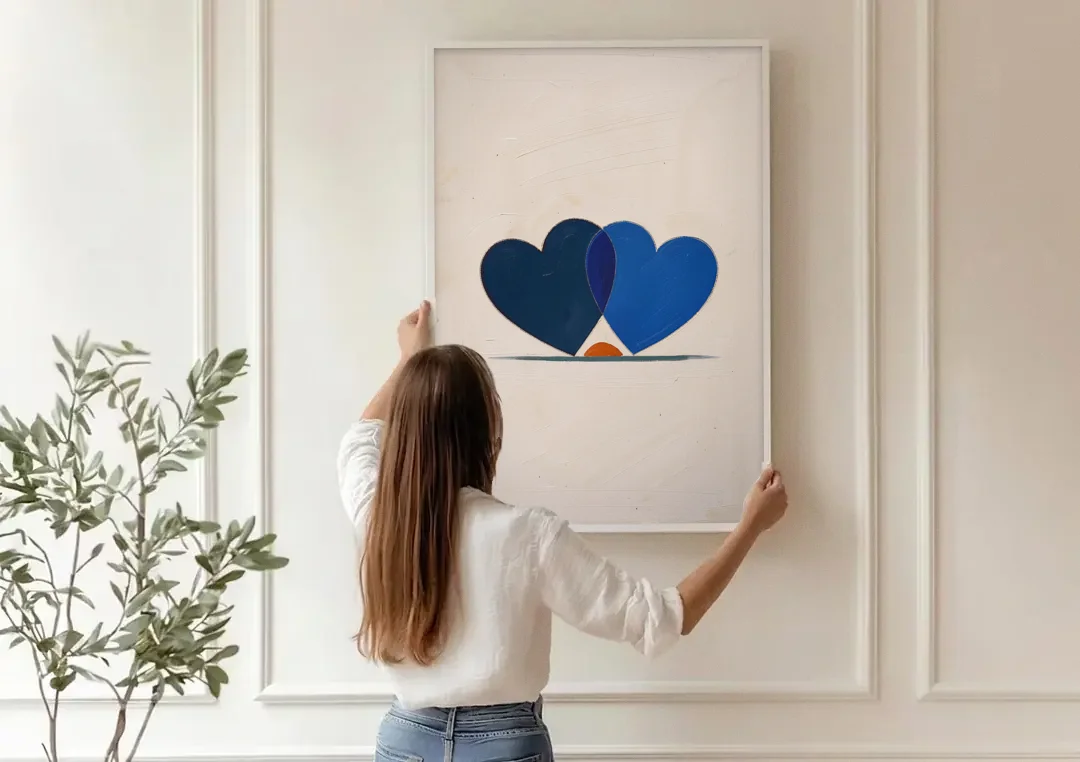 Blue Heart Painting with Ember Crescent canvas wall art being hung on a paneled wall