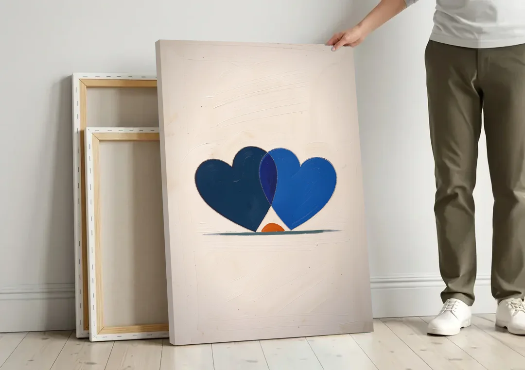 Blue Heart Painting with Ember Crescent canvas wall art leaning against a wall next to blank canvases