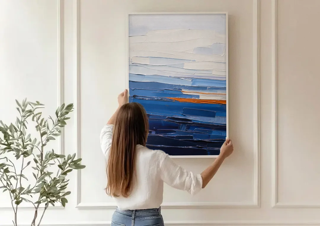 Blue Triptych Wall Art Strata I with Ember Seam canvas wall art being hung on a paneled wall