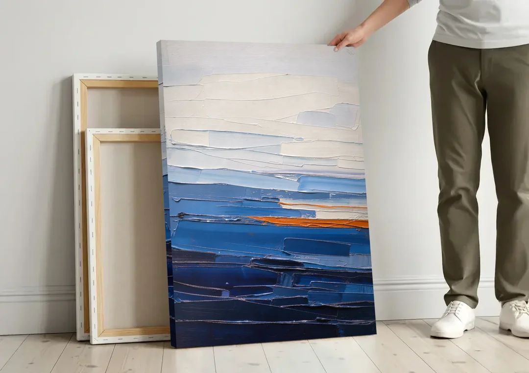 Blue Triptych Wall Art Strata I with Ember Seam canvas wall art leaning against a wall next to blank canvases