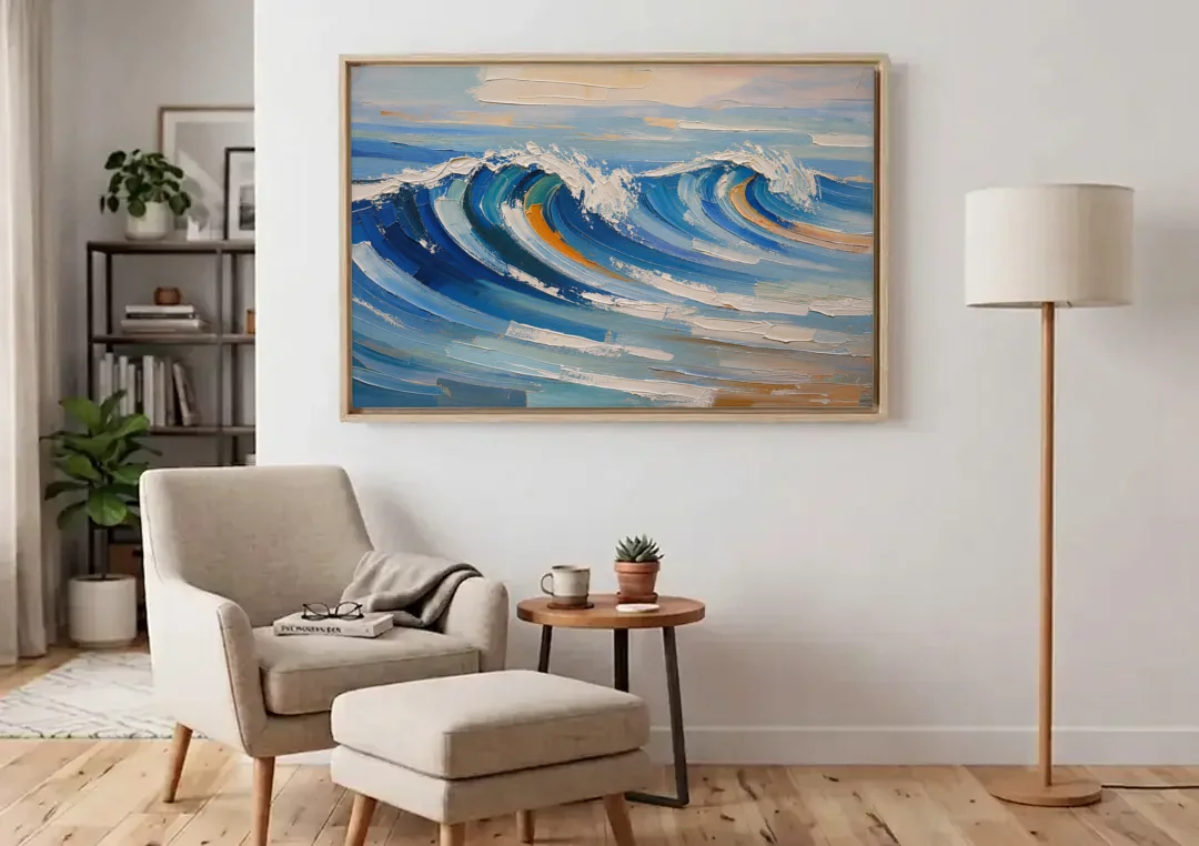 Blue Wall Decor with Cobalt Waves Breaking canvas wall art above an armchair in a bright living room