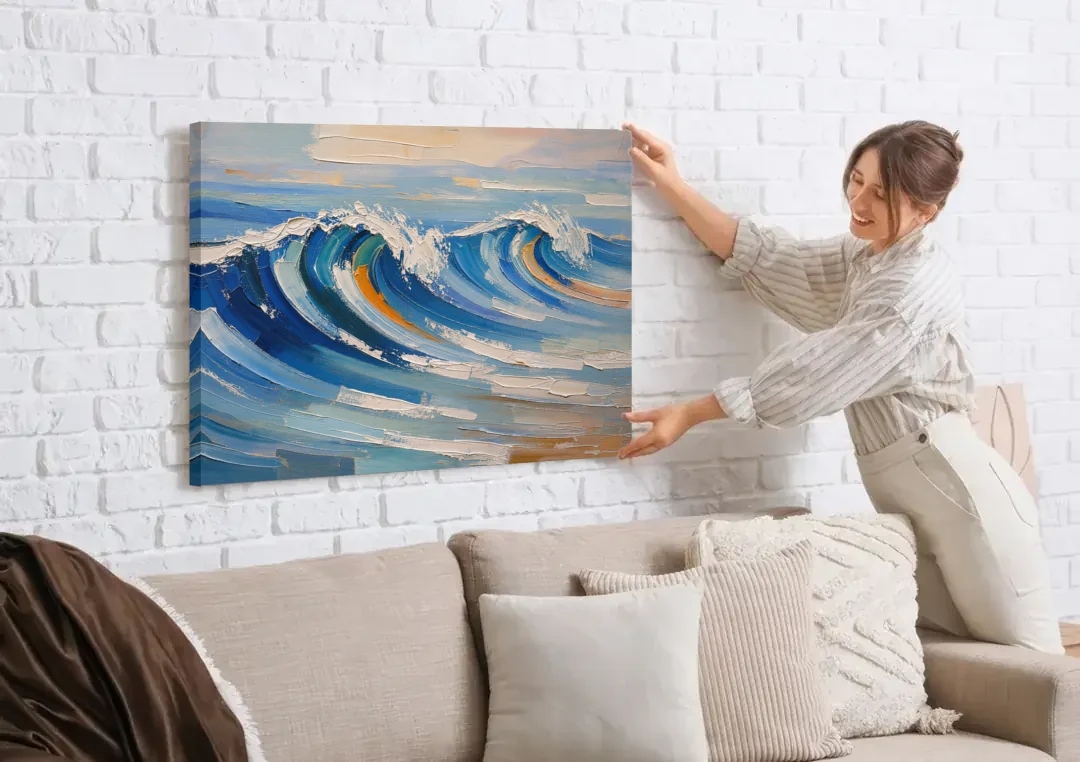 Blue Wall Decor with Cobalt Waves Breaking canvas wall art being hung on a white brick wall above a sofa