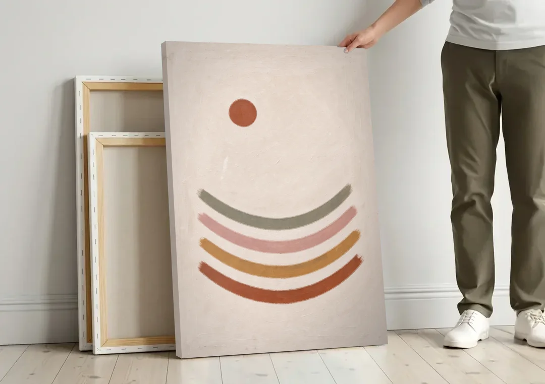 Boho Abstract Art with Clay Sun and Ripples canvas wall art leaning against a wall next to blank canvases