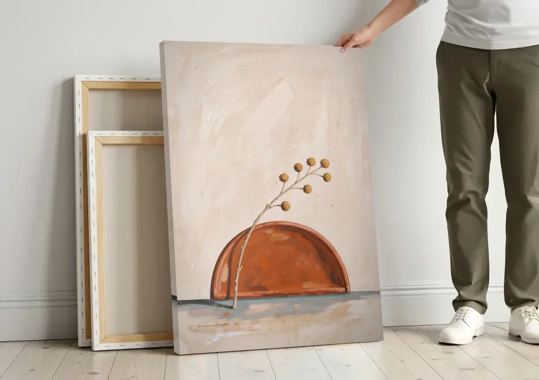 Boho Abstract Wall Art of a Rising Terracotta Dome canvas wall art leaning against a wall next to blank canvases