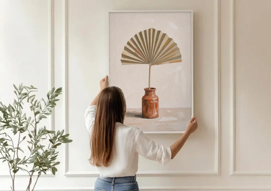 Boho Art Prints Fan Palm in a Clay Bottle canvas wall art being hung on a paneled wall