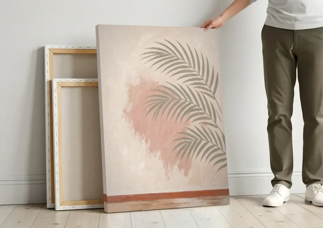 Boho Bathroom Wall Art with Palm Leaf Shadow canvas wall art leaning against a wall next to blank canvases