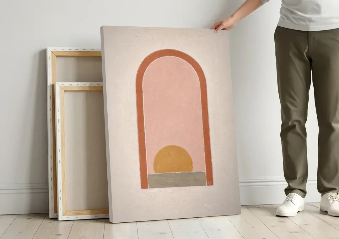 Boho Entryway Decor with Sun in a Tall Arch canvas wall art leaning against a wall next to blank canvases