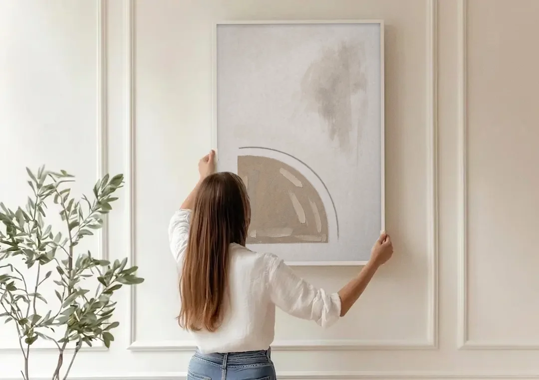 Boho Minimalist Adobe Quarter Circle Under an Ink Arc canvas wall art being hung on a paneled wall