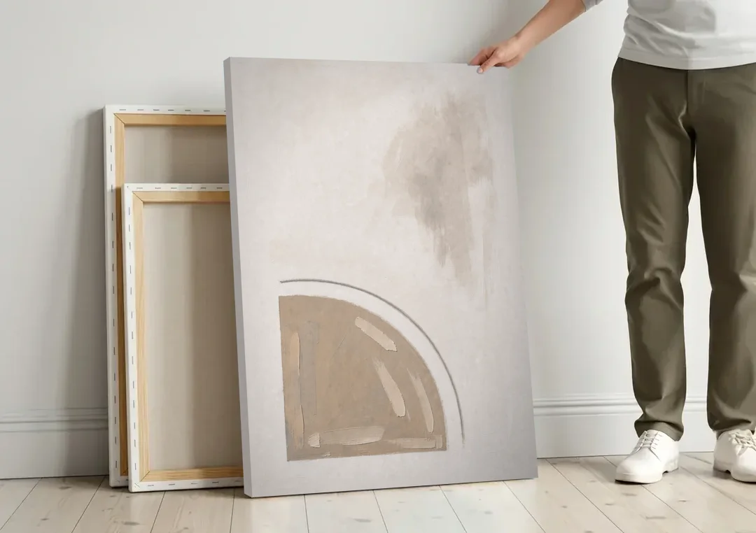 Boho Minimalist Adobe Quarter Circle Under an Ink Arc canvas wall art leaning against a wall next to blank canvases