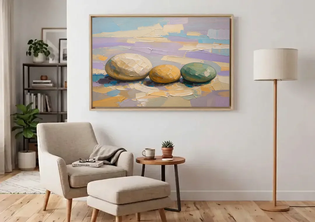 Boho Neutral Pebble Trio in Ivory, Ochre and Sage canvas wall art above an armchair in a bright living room