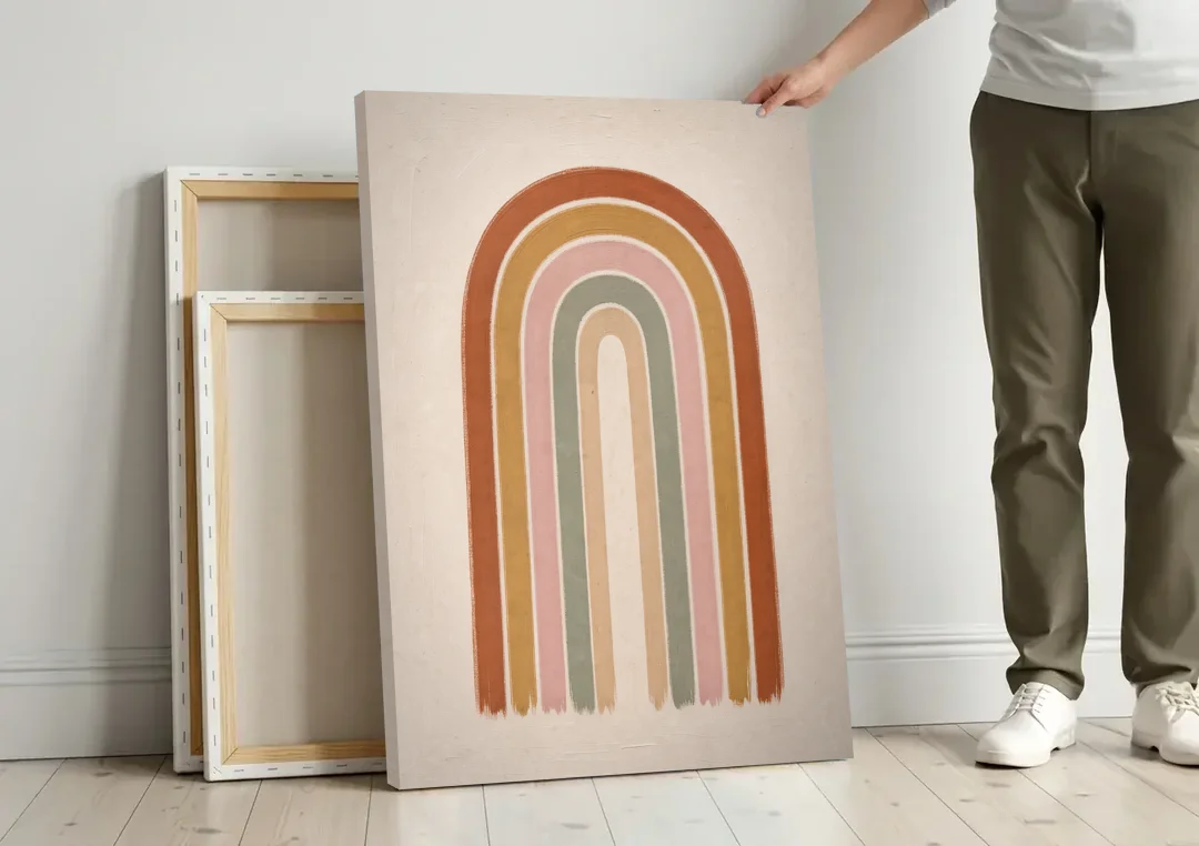 Boho Rainbow Canvas with Tall Painted Bands canvas wall art leaning against a wall next to blank canvases