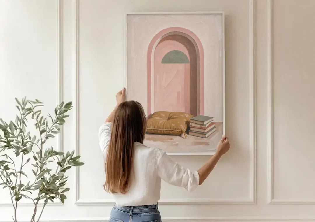 Book Nook Decor with Mustard Cushion in Blush Arch canvas wall art being hung on a paneled wall