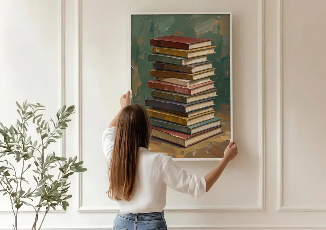Book Stack Wall Art of a Leaning Tower canvas wall art being hung on a paneled wall